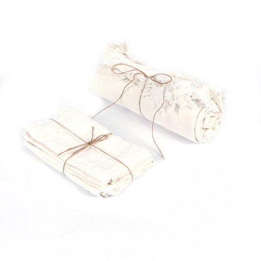 The Linen Tablecloth — White 150×200, lifestyle on low table with ceramics and flowers