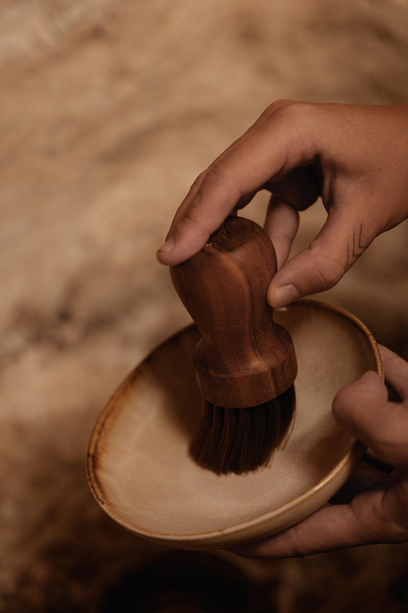 Close-up of the Cascais Small Bowl Plate showing the creamy white interior and burnt-umber rim detail
