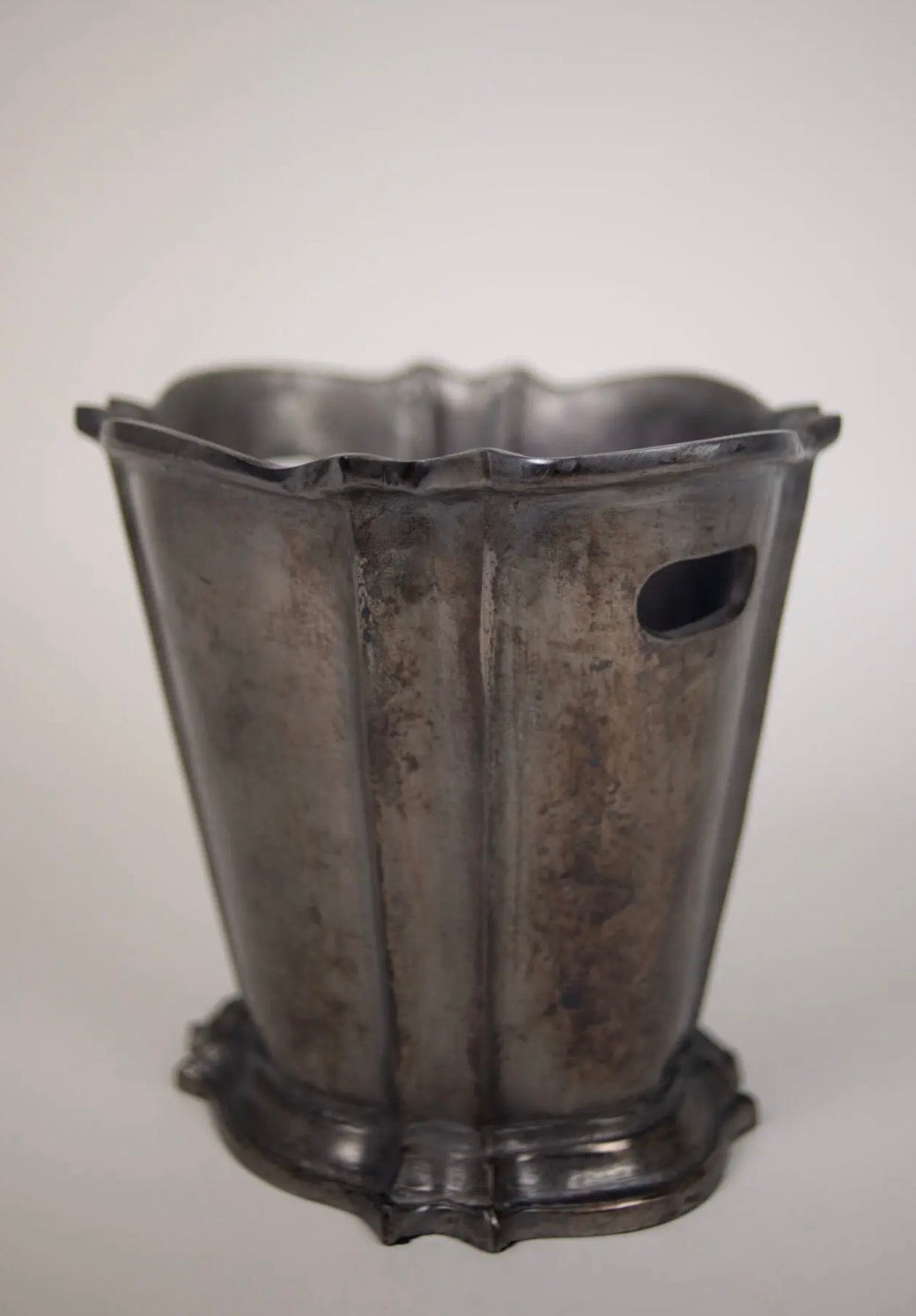 Elara Wine Cooler — three-quarter view showing fluted body, scalloped rim, and footed base on grey background