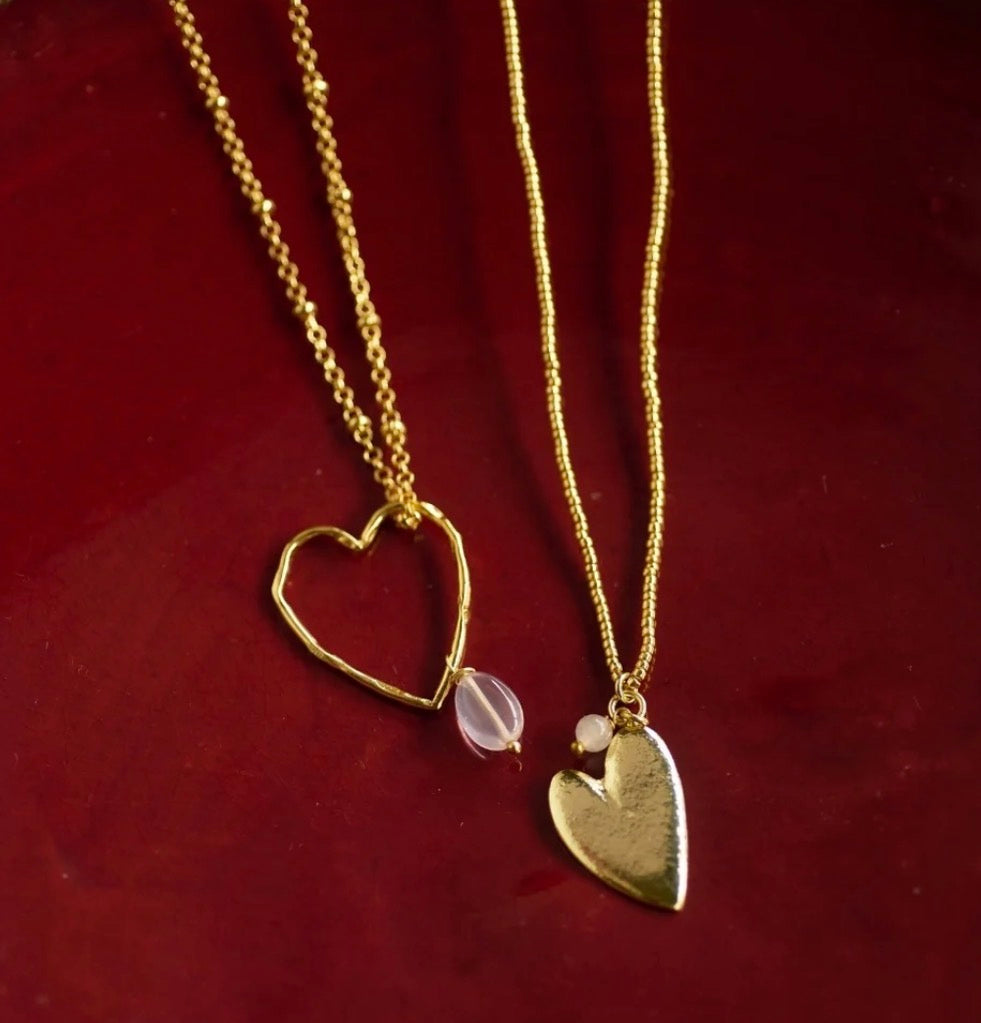 Paradise Rose Quartz Gold Colored Necklace – Styled flat lay on red velvet