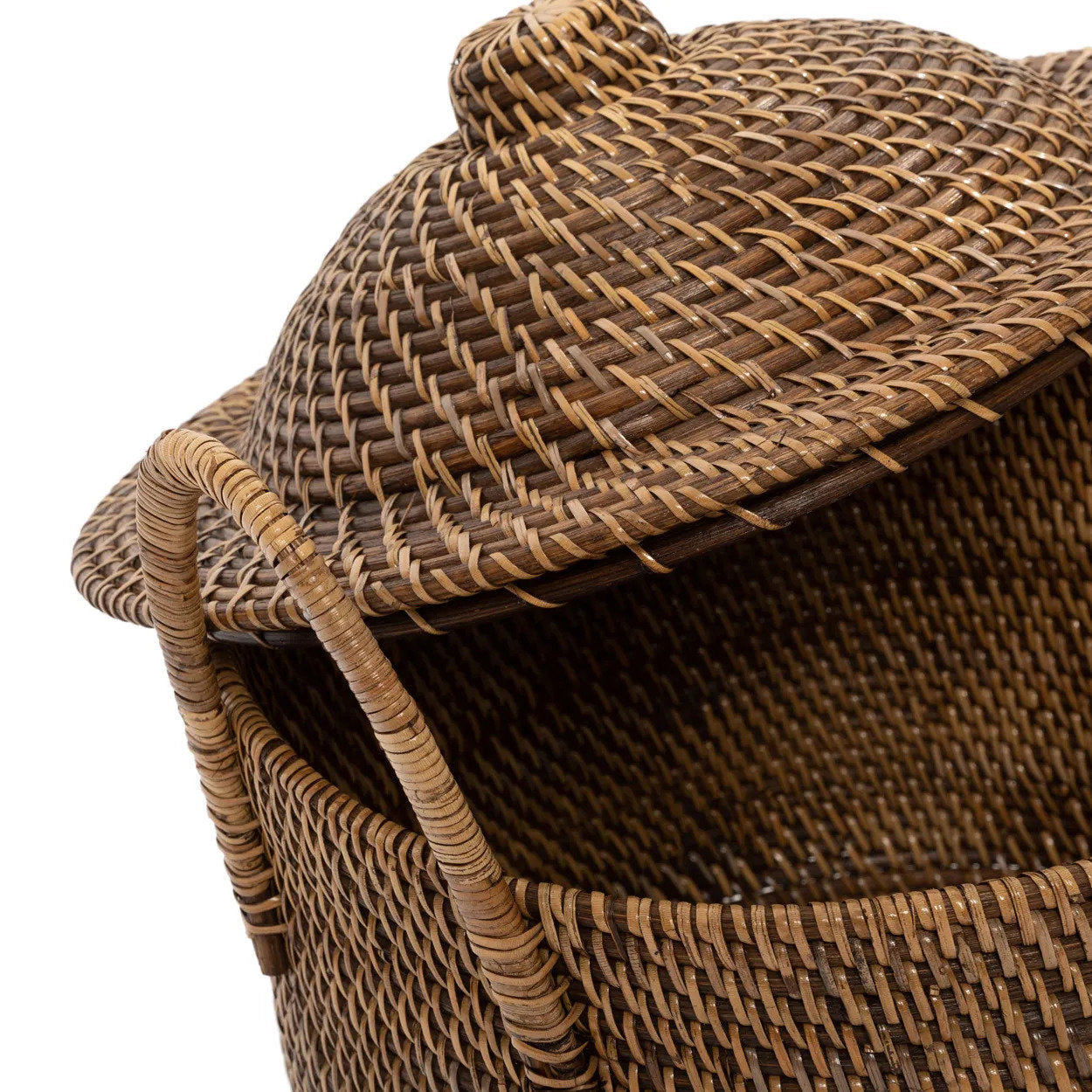 The Colonial Handles Basket in natural brown rattan, styled in a Mediterranean entryway with soft light