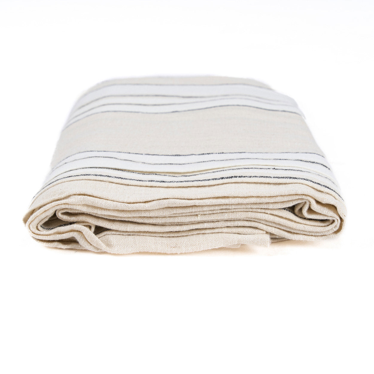 The Provence Tablecloth — Natural Black White 150×250, lifestyle on oak table angled view