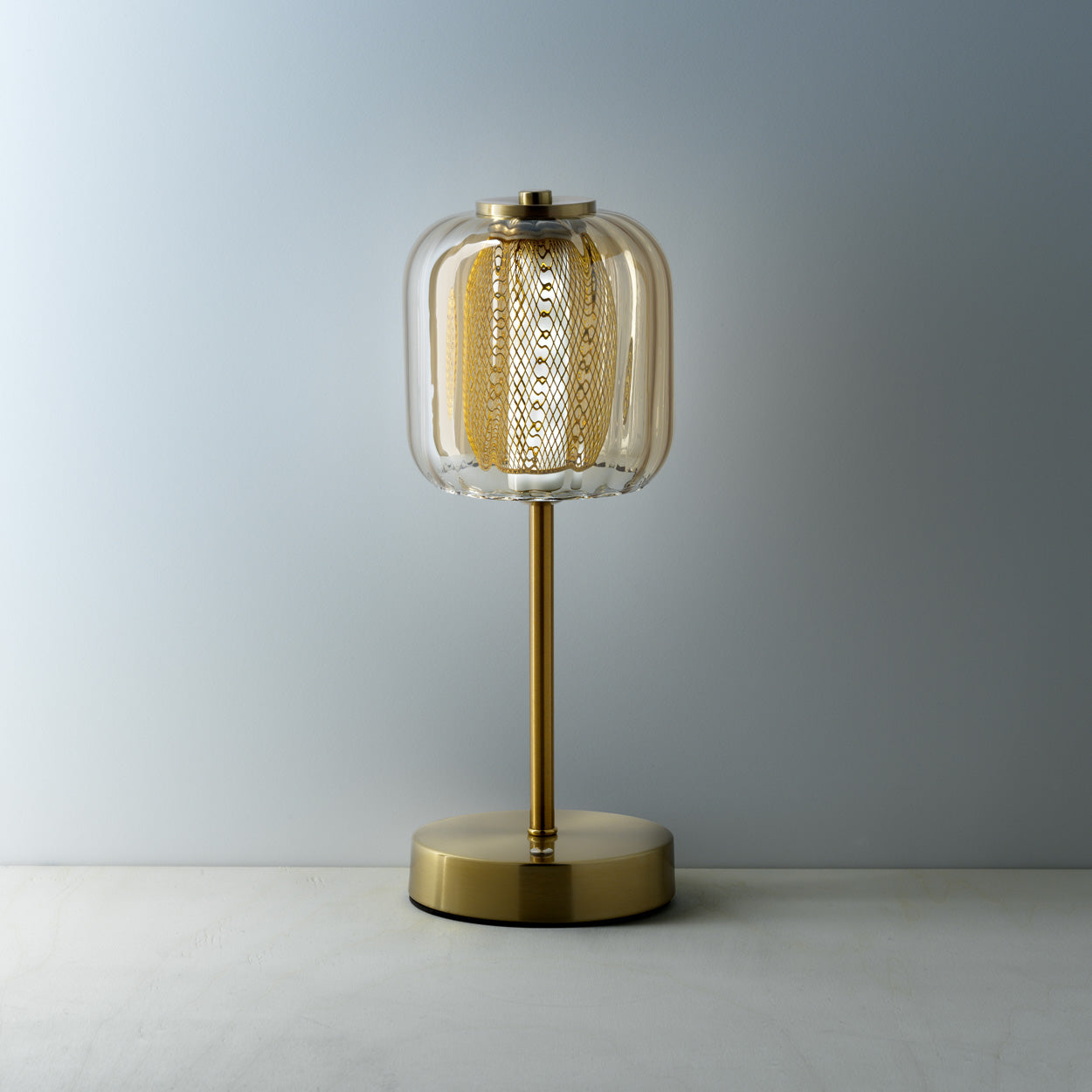 The Lighty Gaga LED Table Lamp, lit warm amber glow