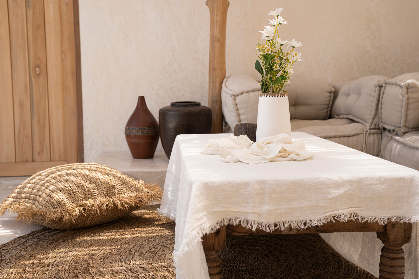 The Linen Tablecloth — White 150×200, rolled and folded set white background