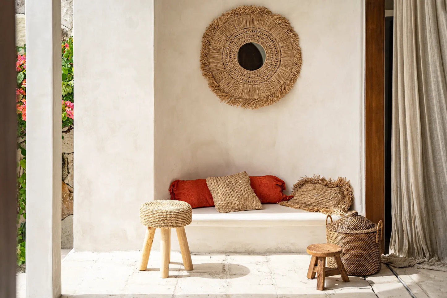 Close-up of the Colonial Handles Basket beside a small wooden stool showing rattan texture and lid detail