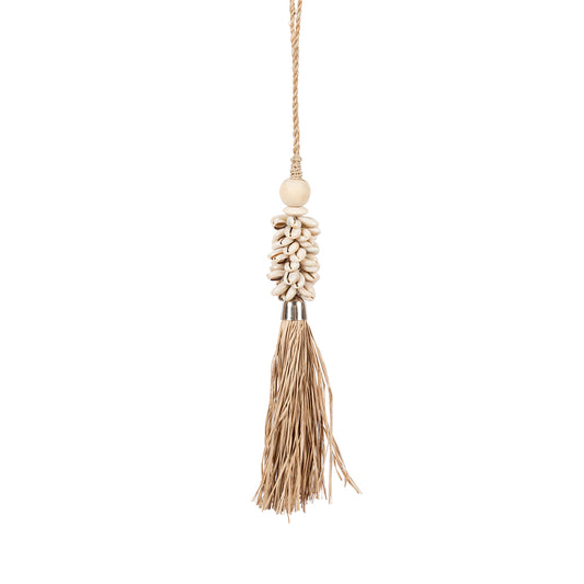The Cowrie & Raffia Tassel — Natural, lifestyle hanging on wooden door