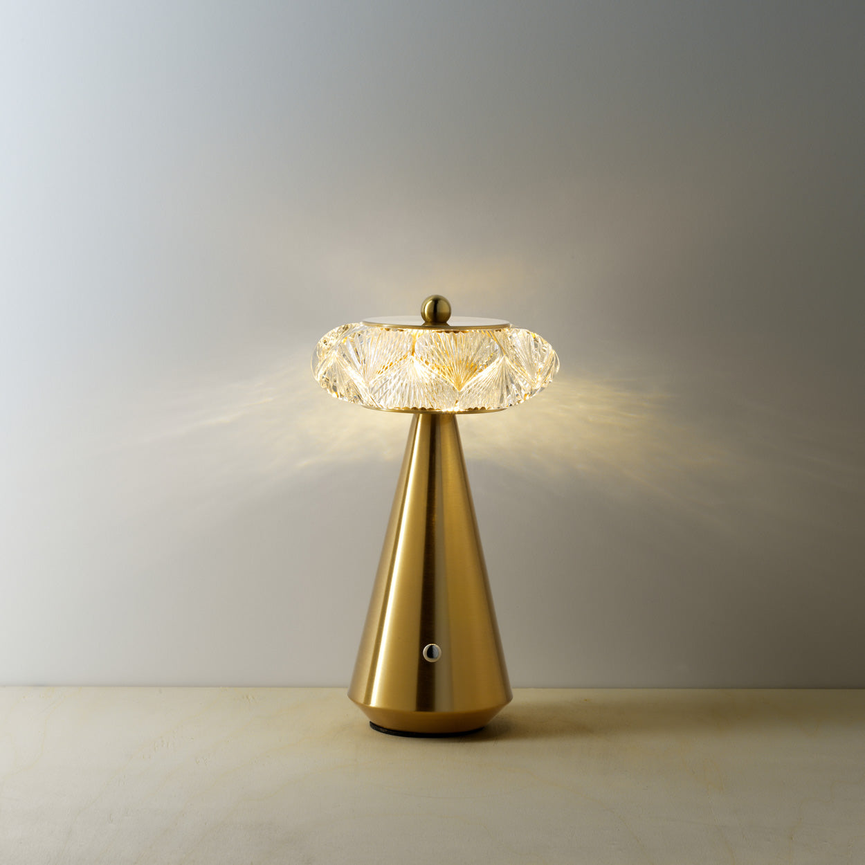 The Diamond Diva LED Table Lamp, warm amber glow grey background