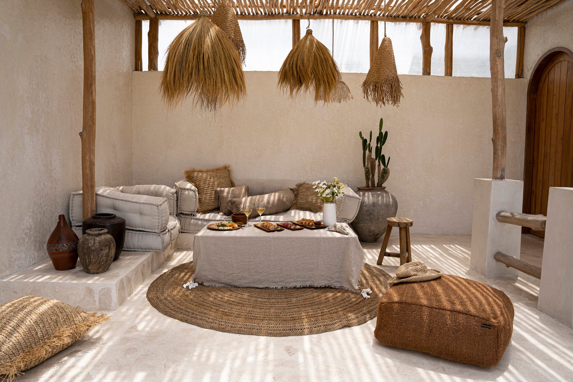 The Linen Tablecloth — Beige 150×150, lifestyle on low table with sushi and wine
