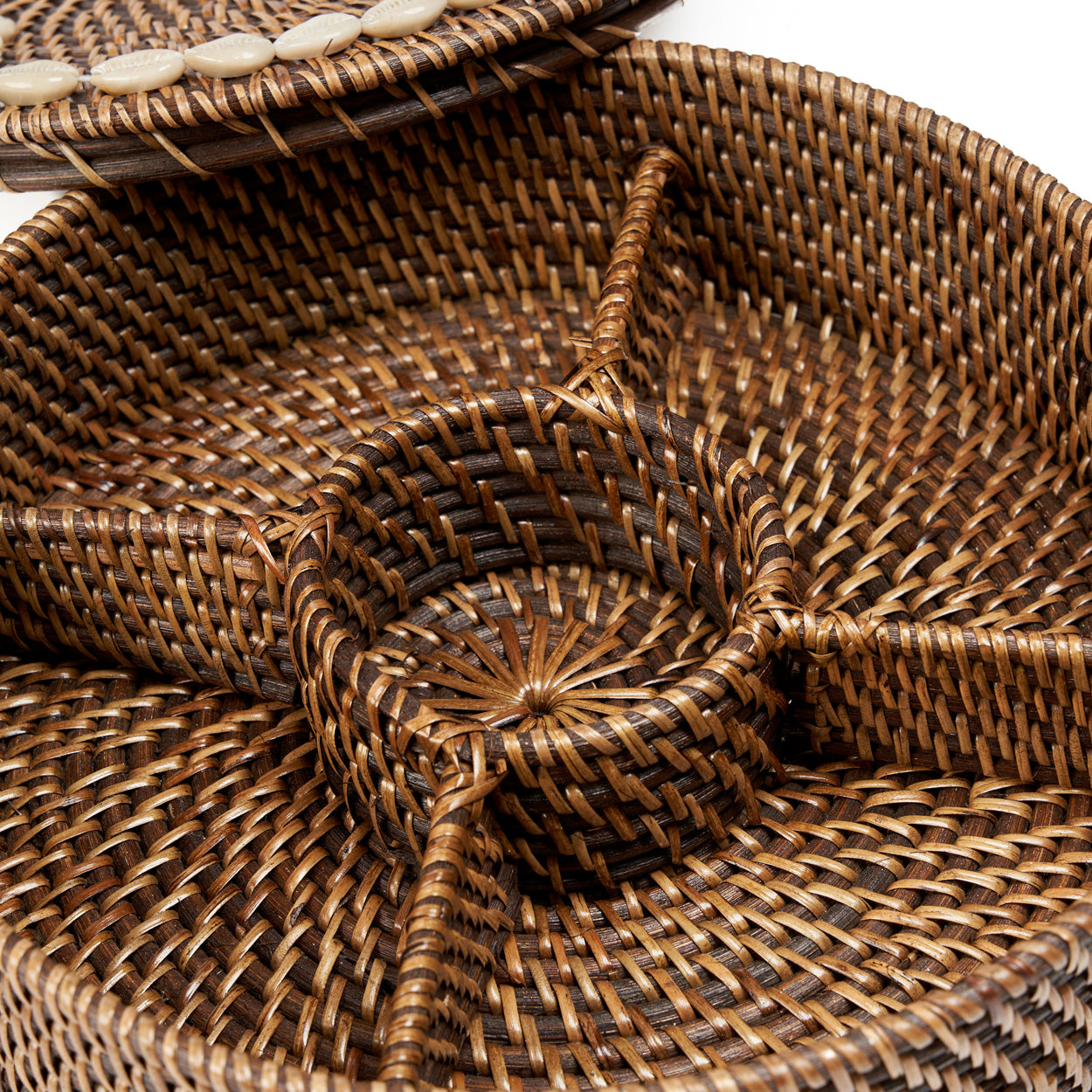 Top-down view of the Rattan Compartment Basket lid and base side by side on white background showing the cowrie shell pattern and interior compartments