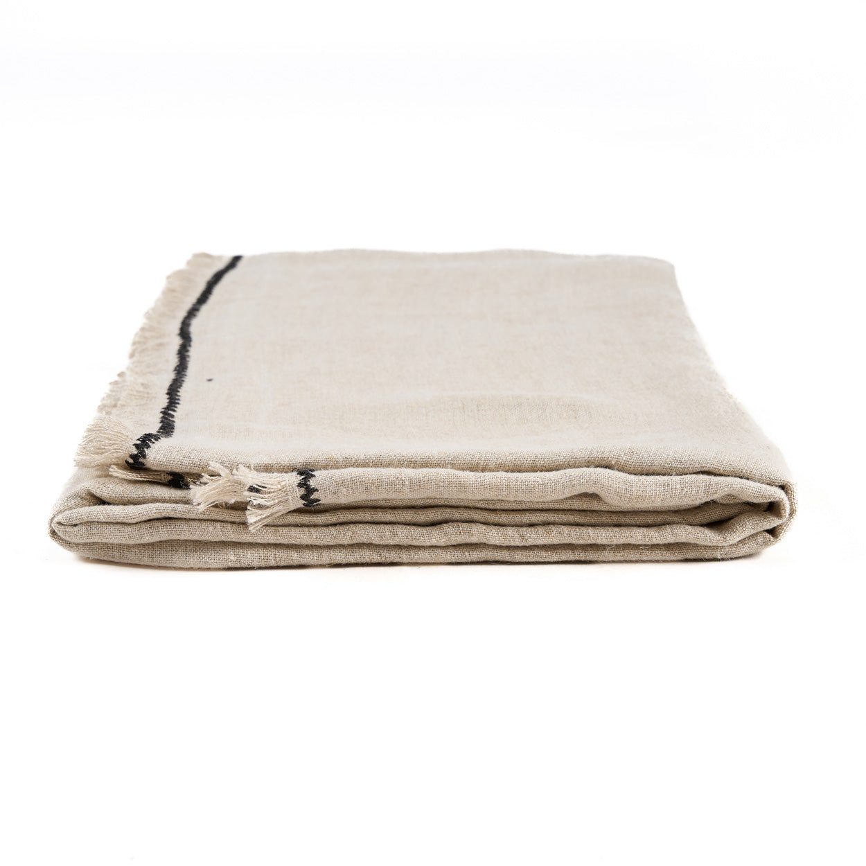 The Tuscany Tablecloth — Natural Black 150×300, draped on table corner detail