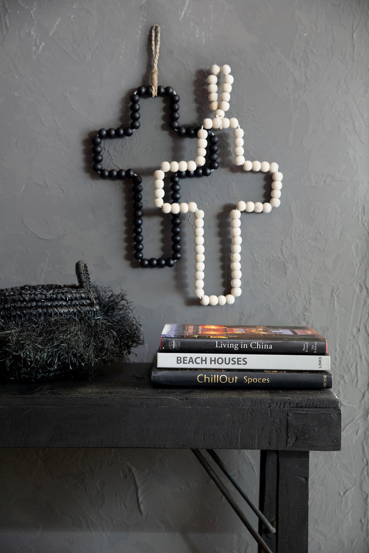 Wooden Bead Cross Natural — styled with black cross on dark wall