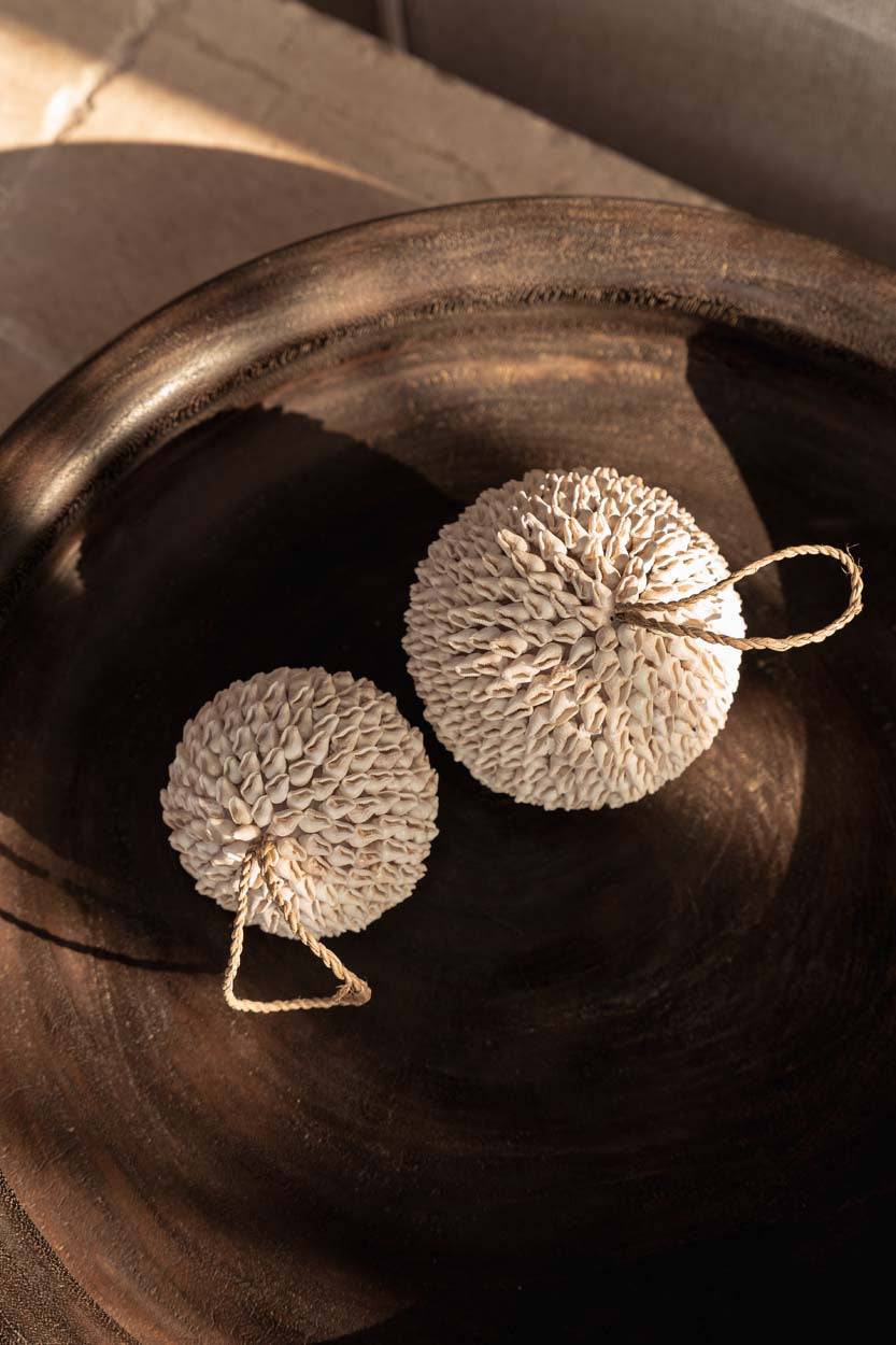 Bubble Shell Ball White — styled with plant and sofa