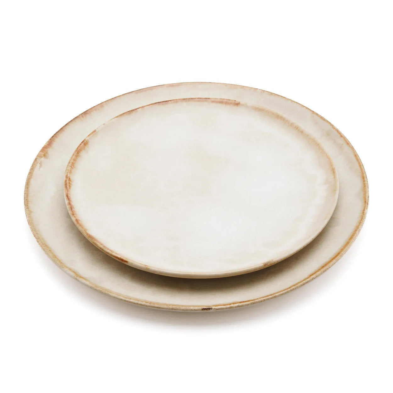The Cascais Dinner Plate angled view showing the organic silhouette and creamy stoneware surface