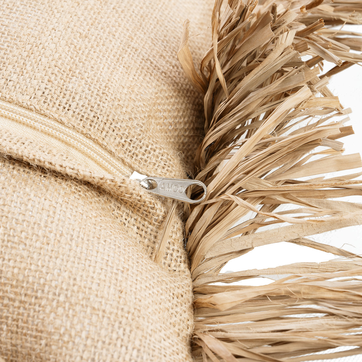 Close-up of the raffia fringe detail on the Jute Bonita Cushion Cover