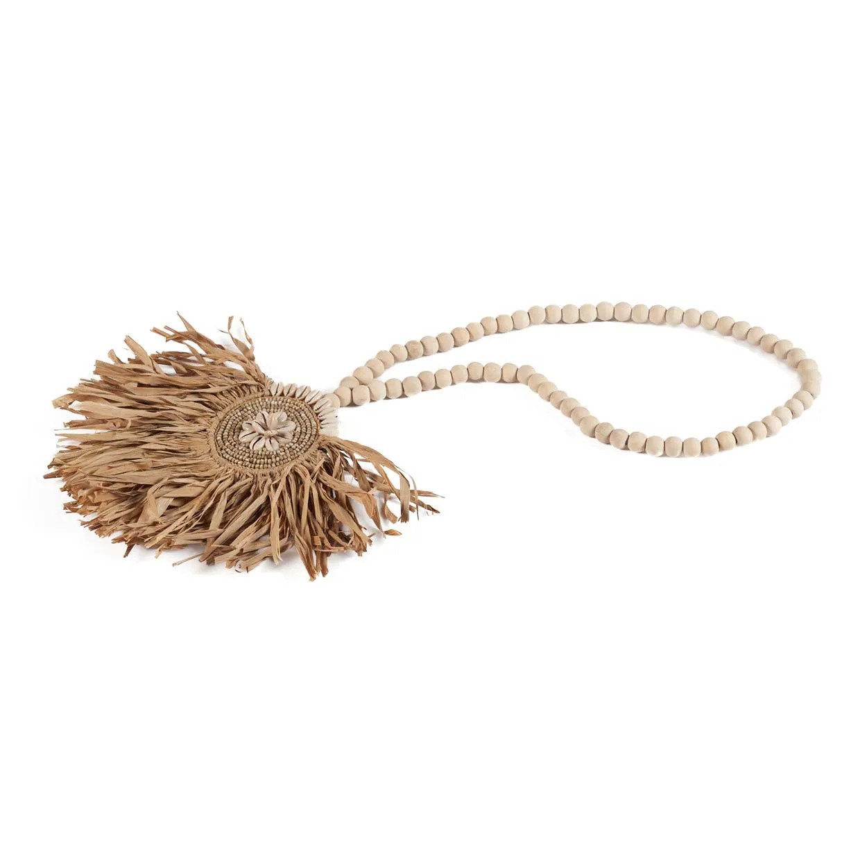 The Raffia Tajoe Tassel — Natural, close-up of cowrie and bead medallion