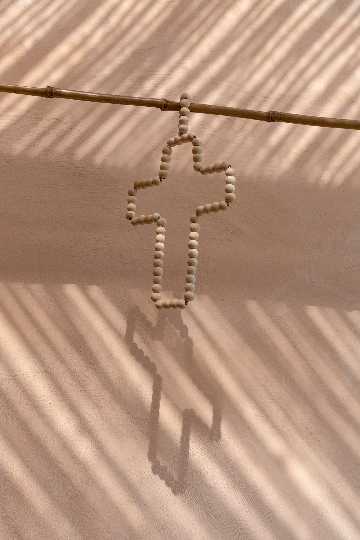 Wooden Bead Cross Natural — angled view on white background