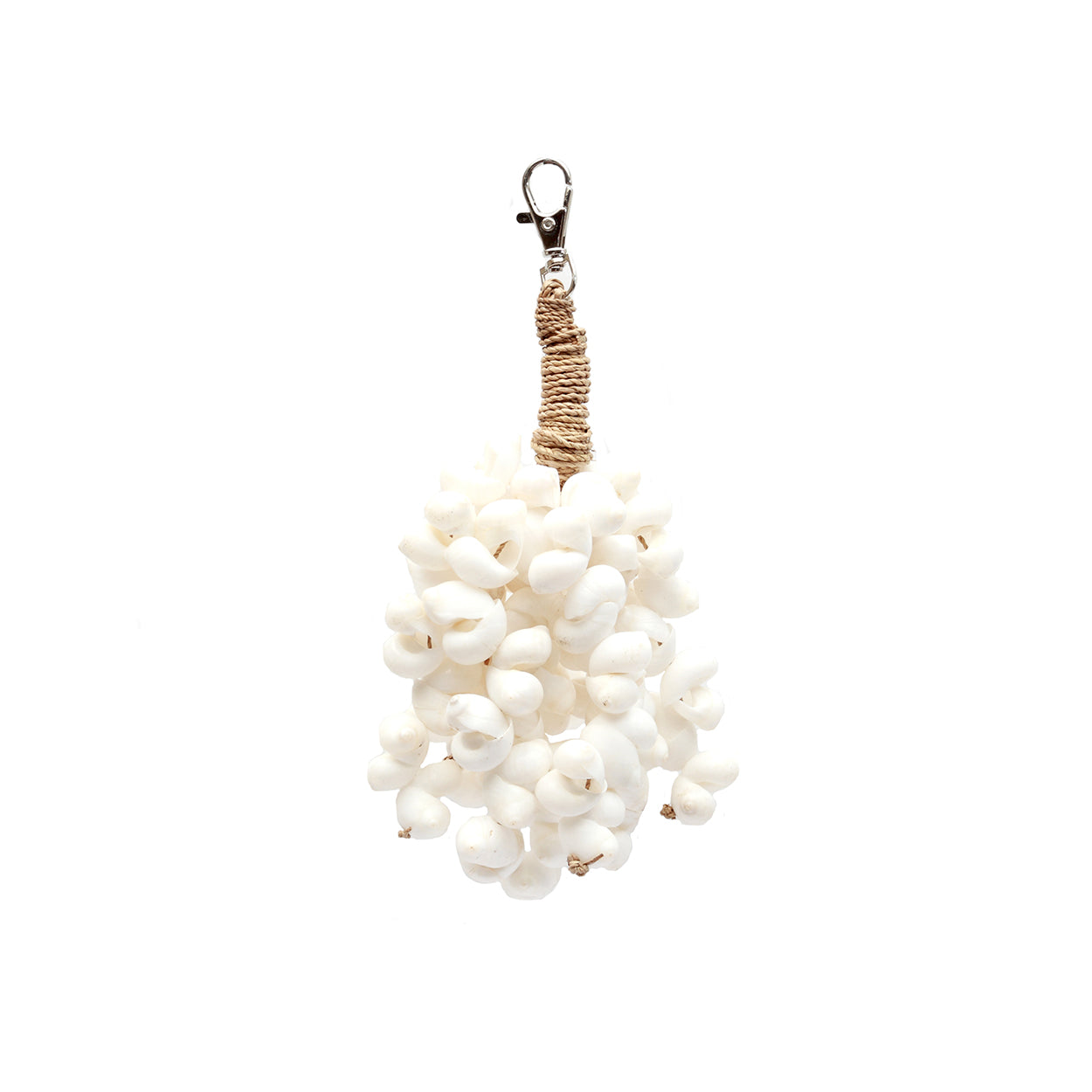 The Kai Shell Keychain — White, lifestyle hanging on aged wooden door with ivy