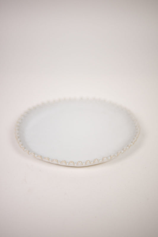Eden Dinner Plate White — round white stoneware plate with textured scalloped rim, top view on warm white background