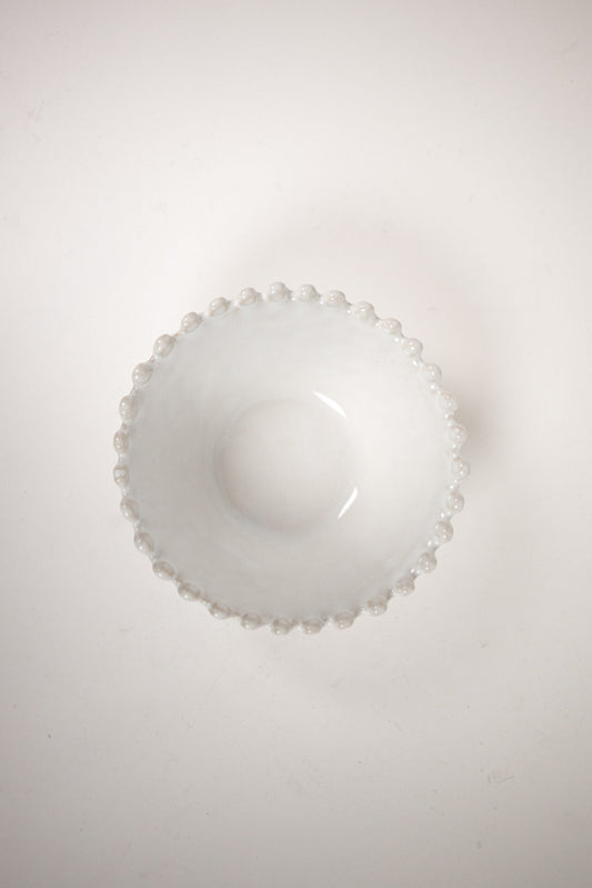 Eden Bowl White — wide shallow white stoneware bowl with beaded rim, top view on warm white background