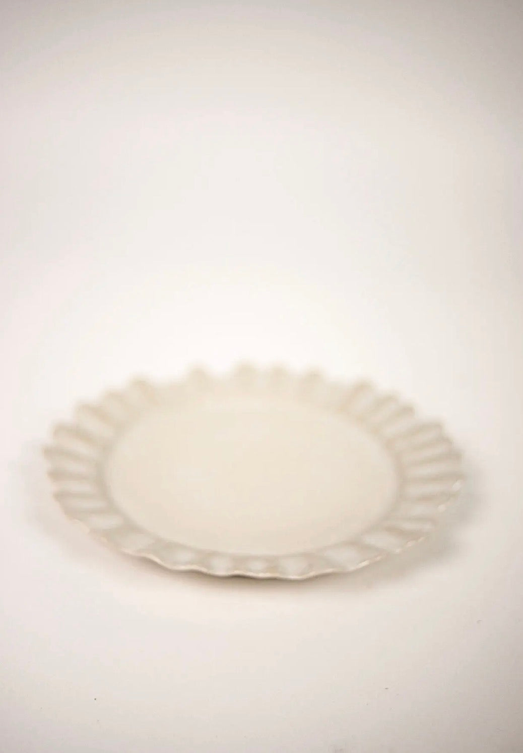 Valerie Dinner Plate White — side view showing wavy edge profile on white background