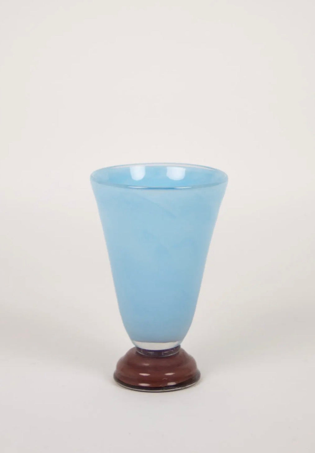 Lolli Vase Small Light Blue — conical light blue glass vase with dark brown base on warm white background