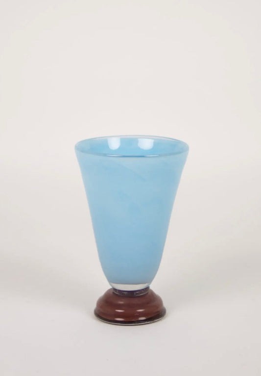 Lolli Vase Small Light Blue — conical light blue glass vase with dark brown base on warm white background