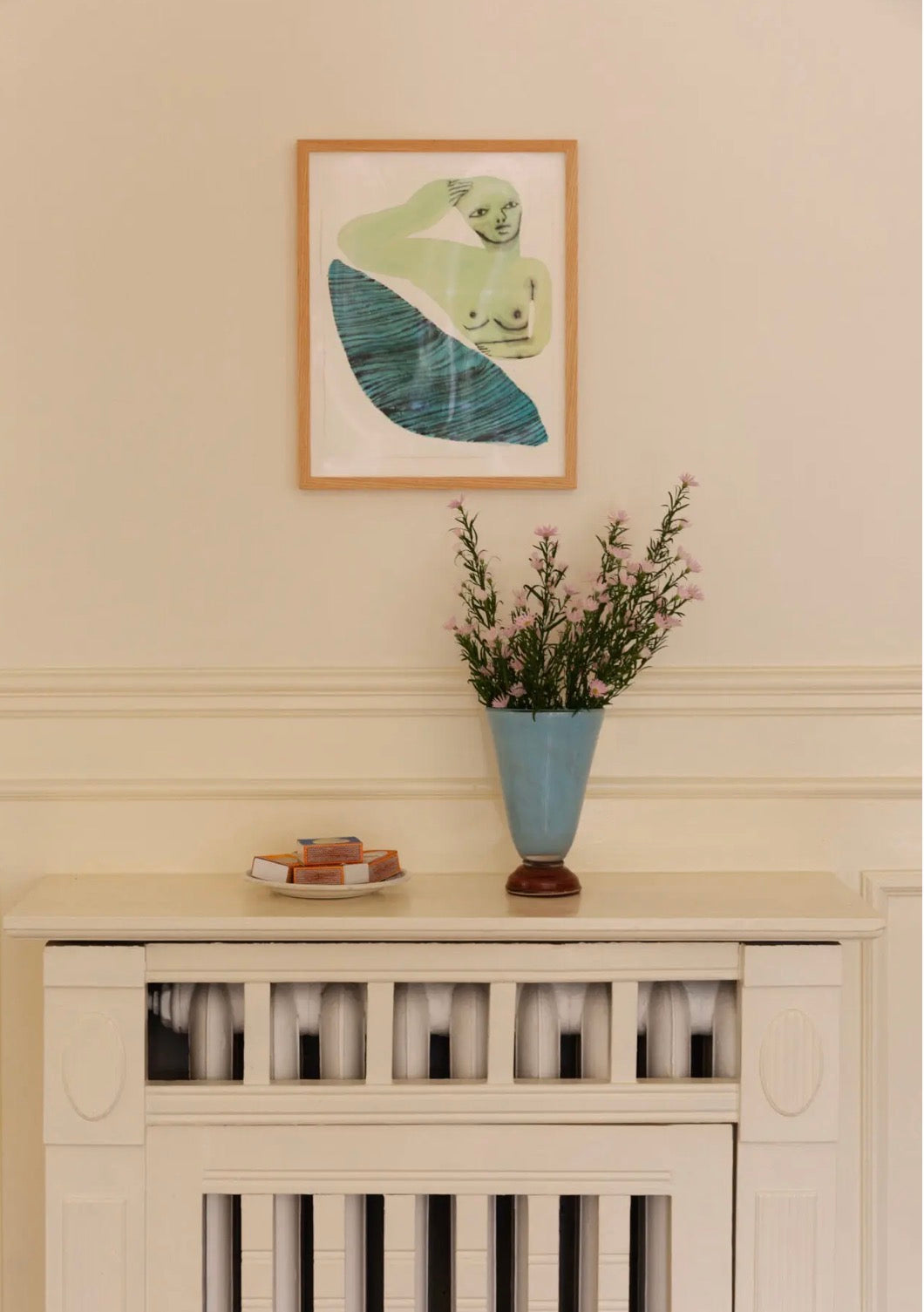 Lolli Vase Small Light Blue — styled on a mantelpiece with dried flowers, framed artwork above