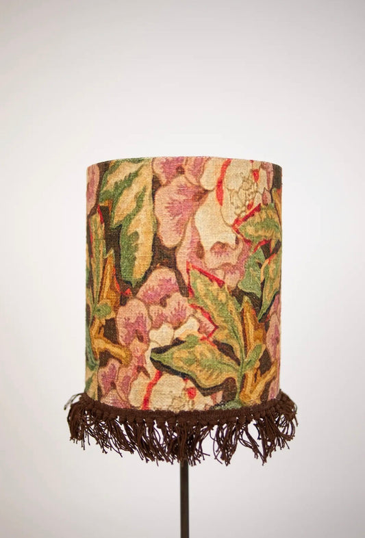 Suzette Lamp Shade — cylindrical cotton lamp shade with botanical tapestry pattern and dark fringe, front view on white background