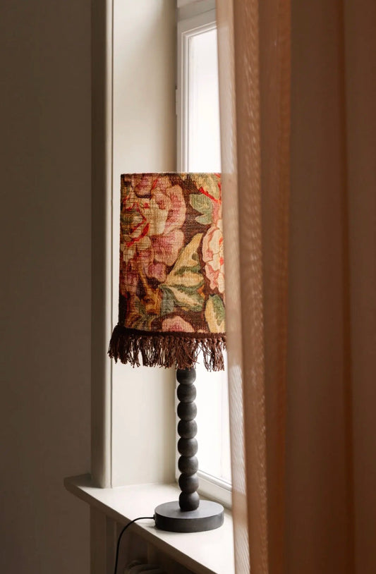 Pete Table Lamp styled with Suzette botanical tapestry shade on windowsill with natural light and linen curtain
