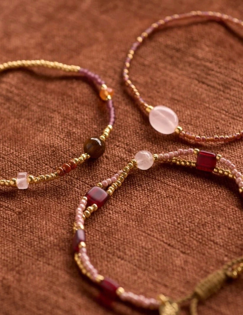 Unwritten Rose Quartz Bracelet – Collection flat lay on fabric