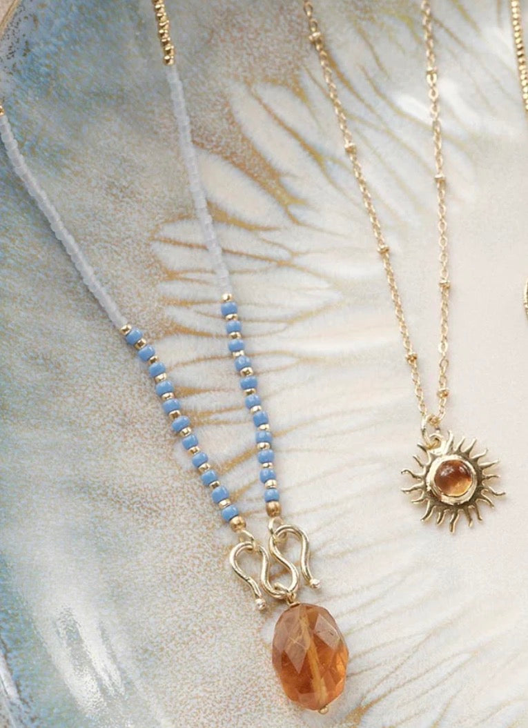 Daring Citrine Necklace – Styled flat lay on shell