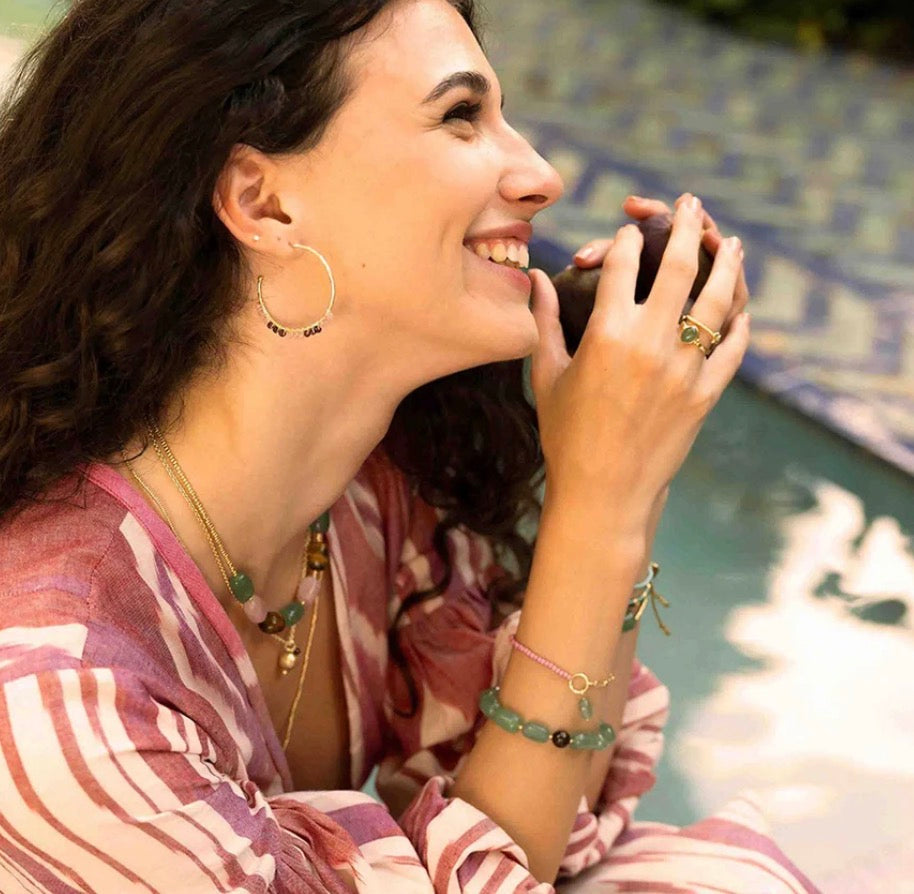 Muse Rose Quartz Garnet Earrings – Model wearing hoop earrings by pool
