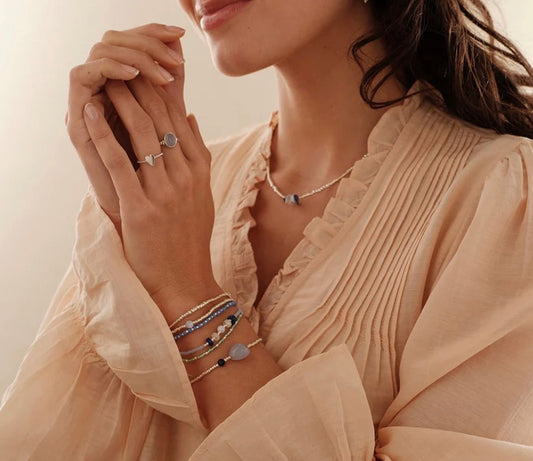 Surprise Blue Lace Agate Bracelet – Model wearing bracelet with layered jewelry