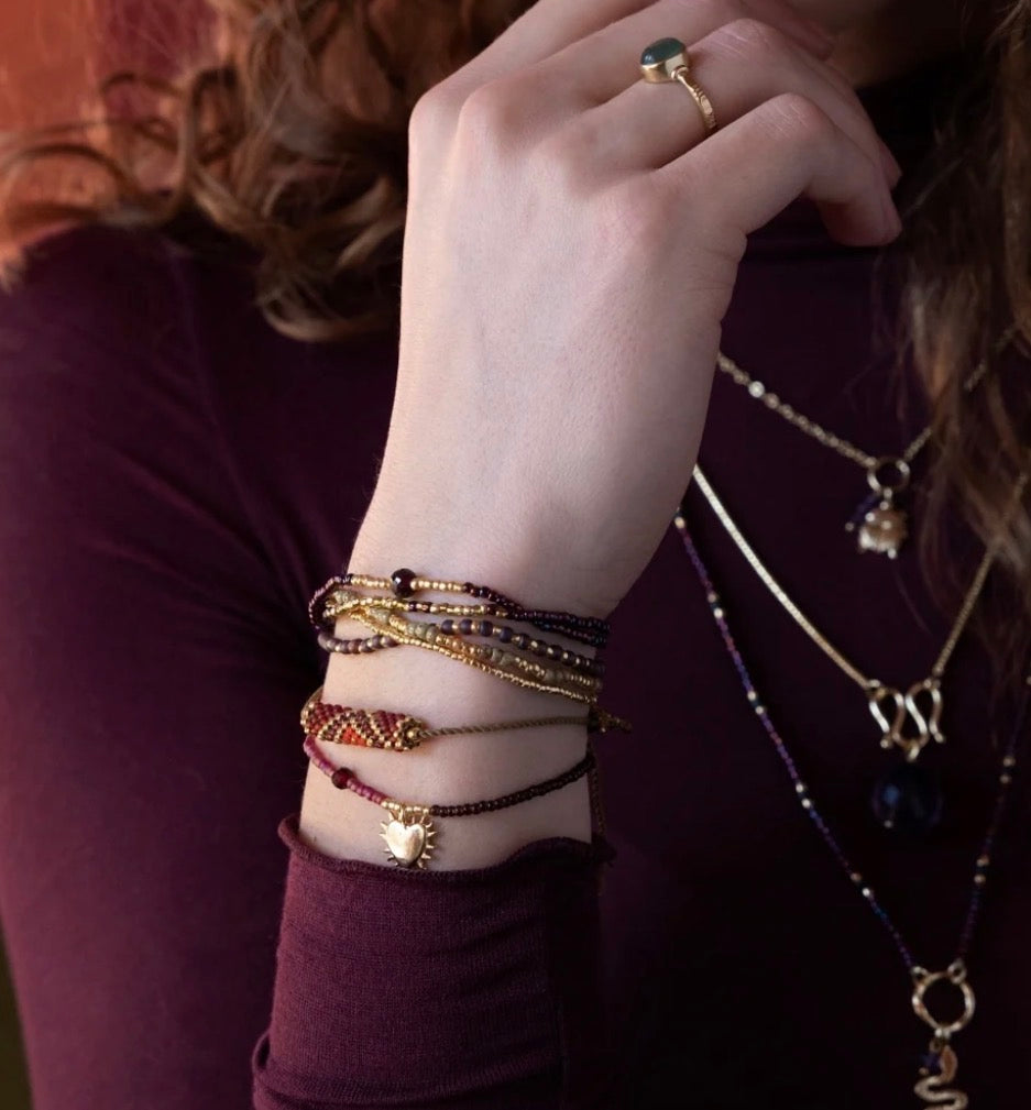 Hoping Garnet Bracelet – Model wearing layered bracelets with heart pendant