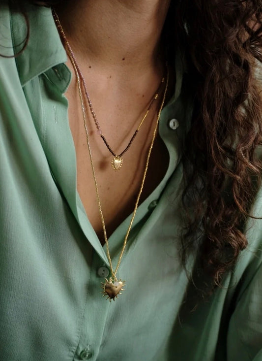 Adventurous Rose Quartz Necklace – Model wearing layered necklaces with heart pendant